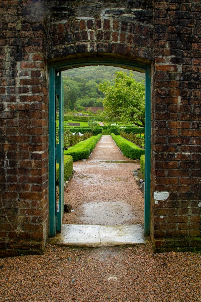 brown brick wall with green grass field